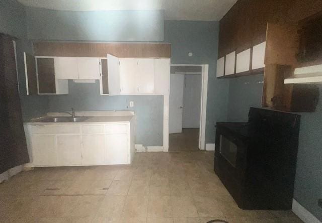 kitchen featuring white cabinets and sink