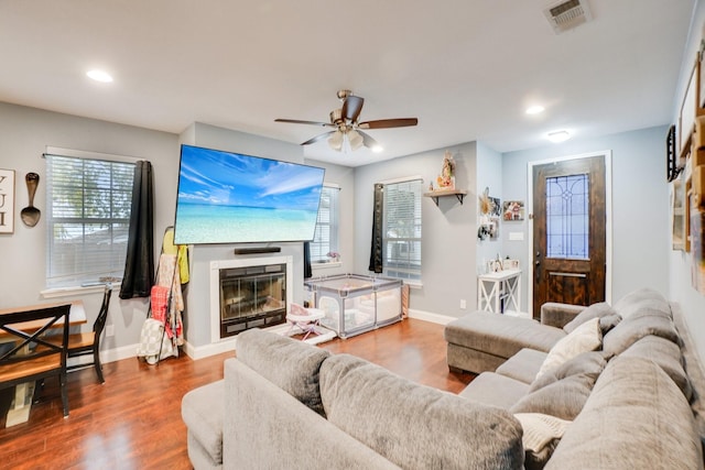 living room featuring hardwood / wood-style floors and ceiling fan