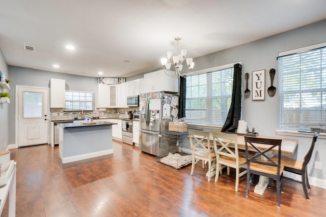 kitchen featuring a healthy amount of sunlight, white cabinetry, and stainless steel appliances