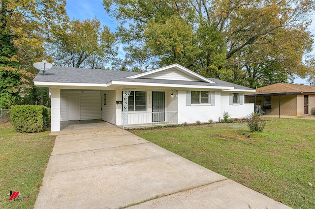 ranch-style house with a front lawn, covered porch, and a carport