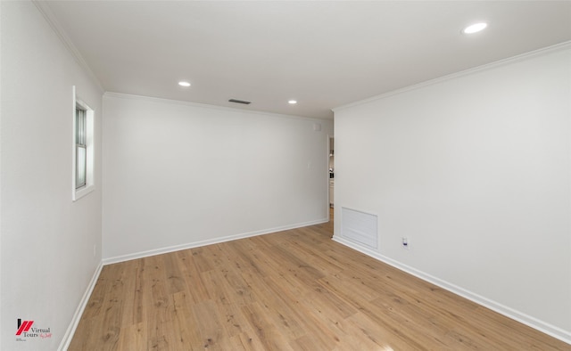 spare room with crown molding and light hardwood / wood-style flooring