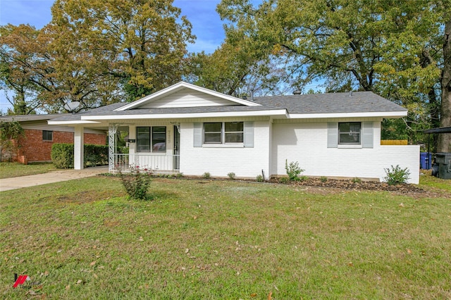 ranch-style house featuring a front yard, a porch, and a carport