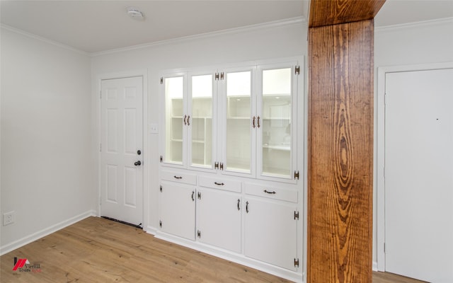 doorway featuring light hardwood / wood-style floors and crown molding