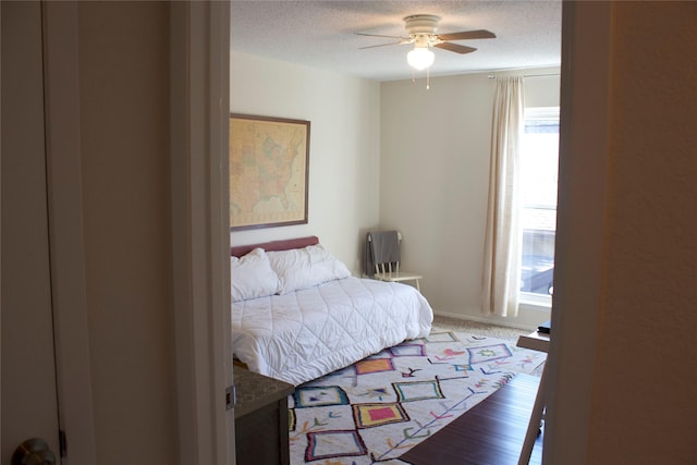 bedroom featuring a textured ceiling and ceiling fan