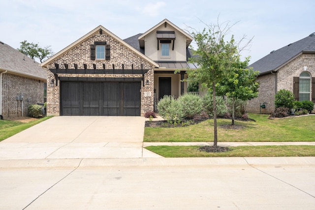 view of front facade featuring a front yard and a garage