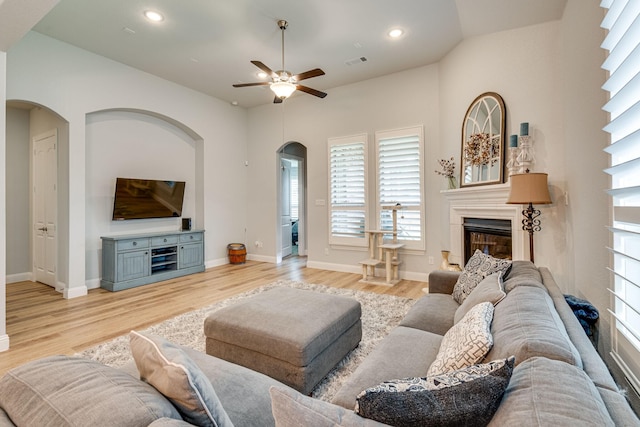 living room with light hardwood / wood-style flooring and ceiling fan