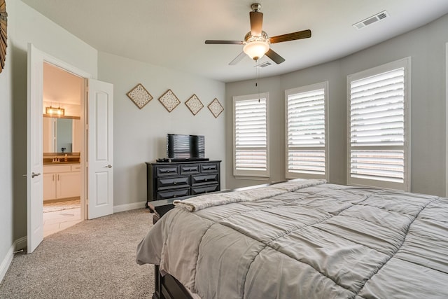 carpeted bedroom featuring ceiling fan and ensuite bathroom