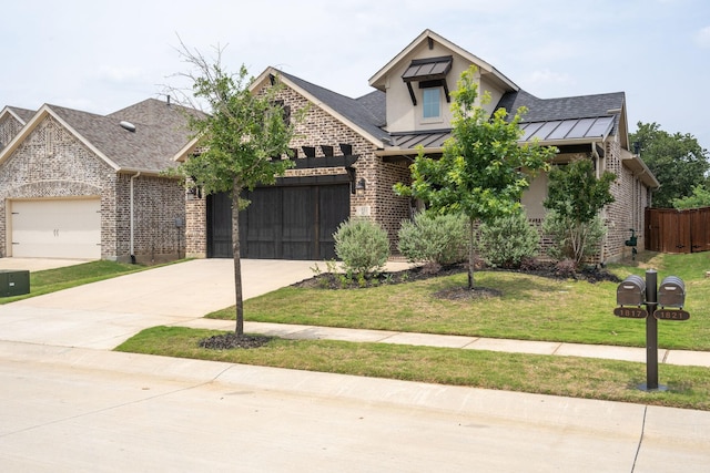 view of front of home with a garage and a front yard