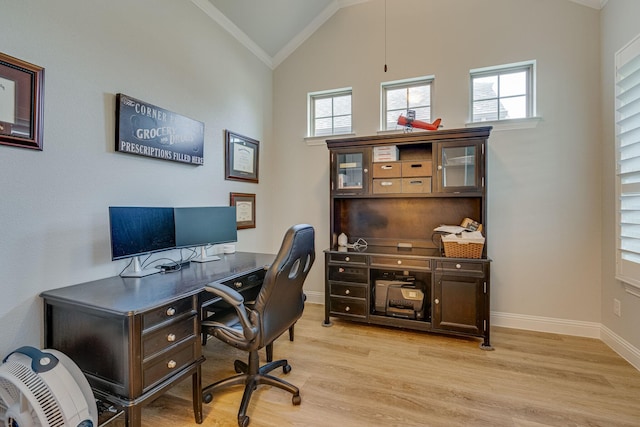 home office featuring a healthy amount of sunlight, light wood-type flooring, and vaulted ceiling