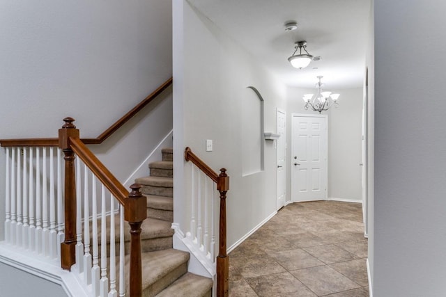 foyer entrance featuring an inviting chandelier and light tile patterned flooring