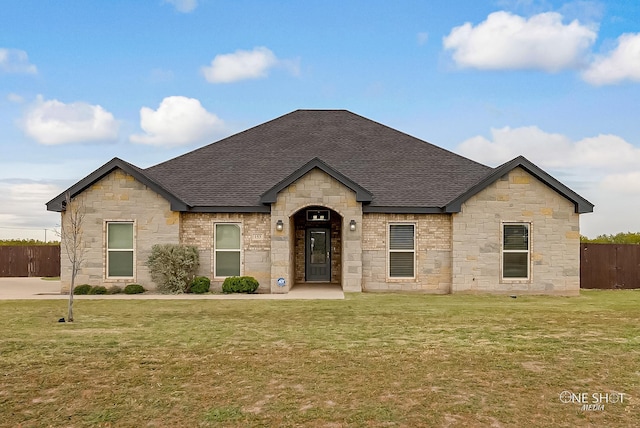 french provincial home with a front lawn