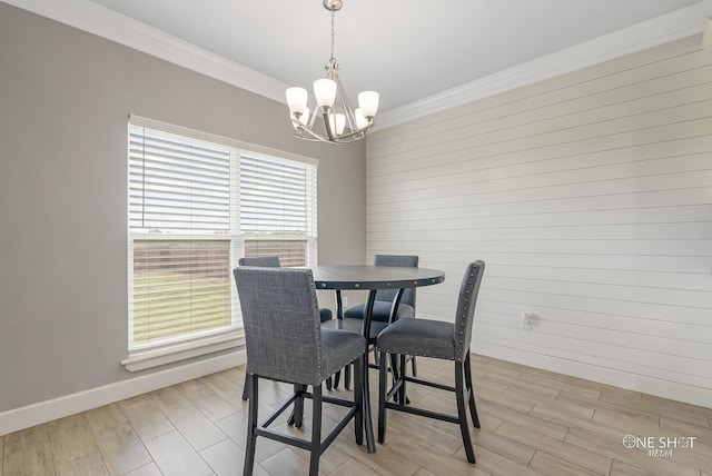 dining area with ornamental molding and a notable chandelier