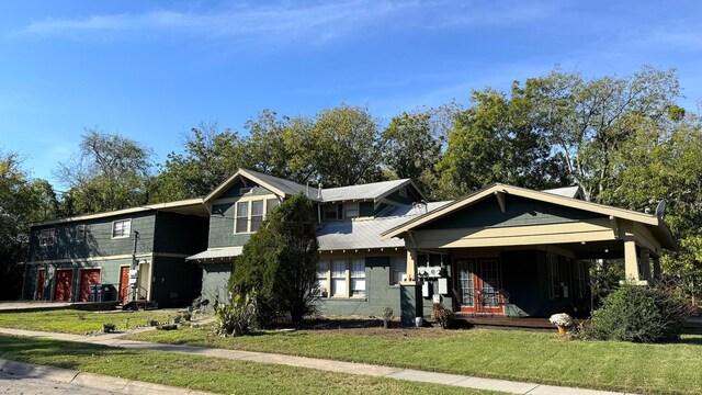 view of front facade featuring covered porch and a front yard