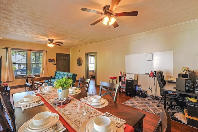 dining room with ceiling fan, hardwood / wood-style floors, and a textured ceiling