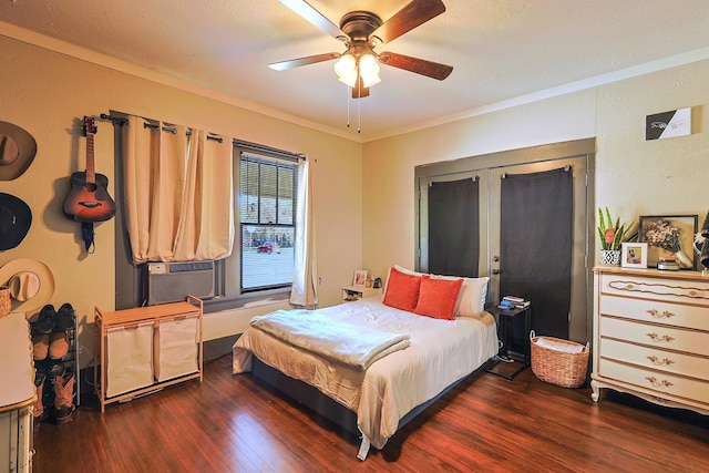 bedroom with ceiling fan, french doors, dark hardwood / wood-style floors, and ornamental molding