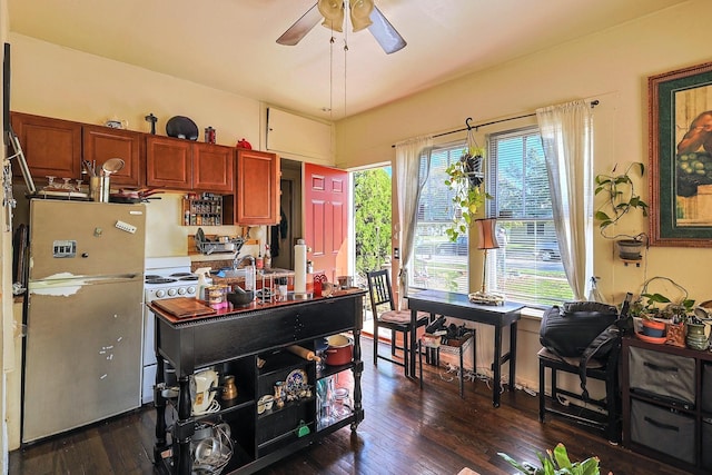 kitchen with stainless steel fridge, dark hardwood / wood-style flooring, white stove, and a wealth of natural light