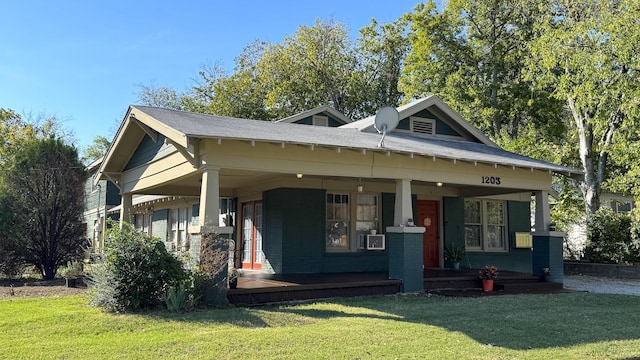 view of front of home featuring covered porch and a front yard