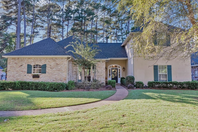 9622 Norris Ferry Rd, Shreveport, LA 71106 - view of front of home featuring a front yard, a shingled roof, brick siding, and stucco siding