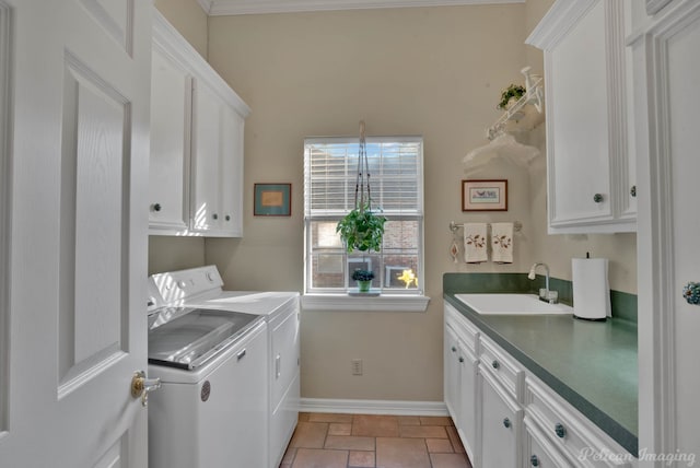 laundry room featuring cabinets, washing machine and dryer, ornamental molding, and sink