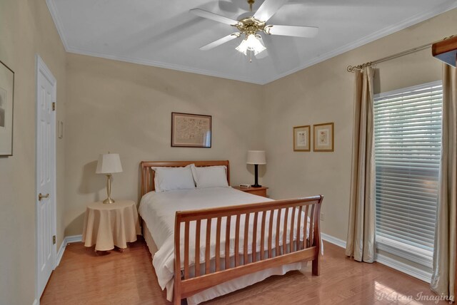 bedroom with light hardwood / wood-style flooring, ceiling fan, and crown molding