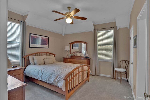 carpeted bedroom with multiple windows, ornamental molding, and ceiling fan