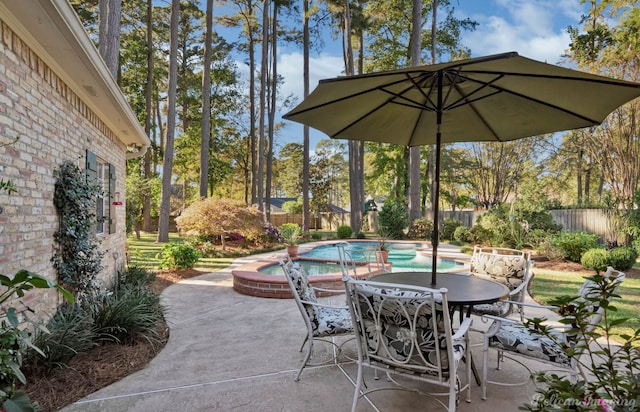 view of patio with a swimming pool with hot tub