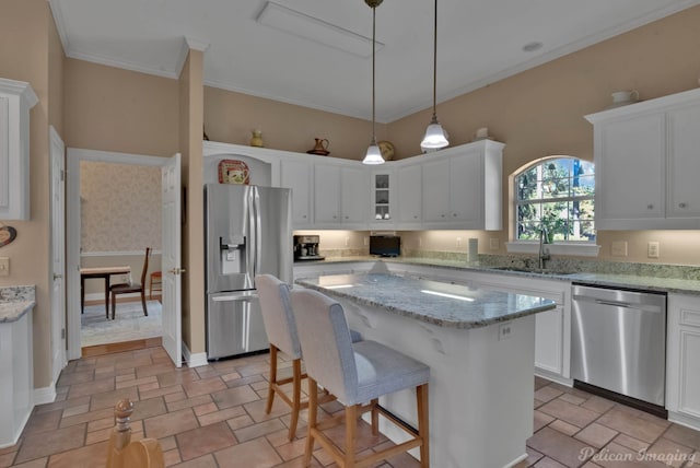 9622 Norris Ferry Rd, Shreveport, LA 71106 - kitchen featuring stainless steel appliances, white cabinetry, a center island, stone tile floors, and decorative light fixtures