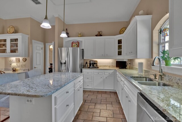 kitchen featuring white cabinets, a kitchen bar, stainless steel appliances, and sink