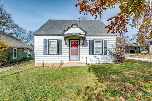 bungalow-style house featuring a front yard