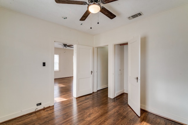 unfurnished bedroom featuring ceiling fan and dark hardwood / wood-style flooring