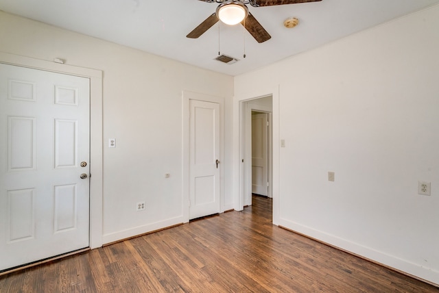 spare room featuring ceiling fan and dark hardwood / wood-style flooring