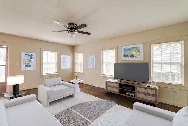 living room with dark hardwood / wood-style floors, plenty of natural light, and ceiling fan