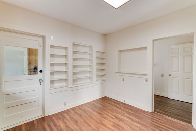 interior space with built in features and wood-type flooring