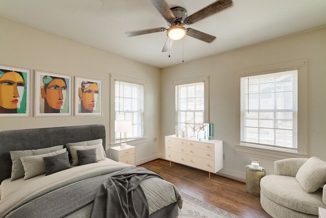 bedroom with ceiling fan and dark hardwood / wood-style floors