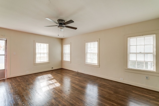 spare room with dark wood-type flooring and a healthy amount of sunlight