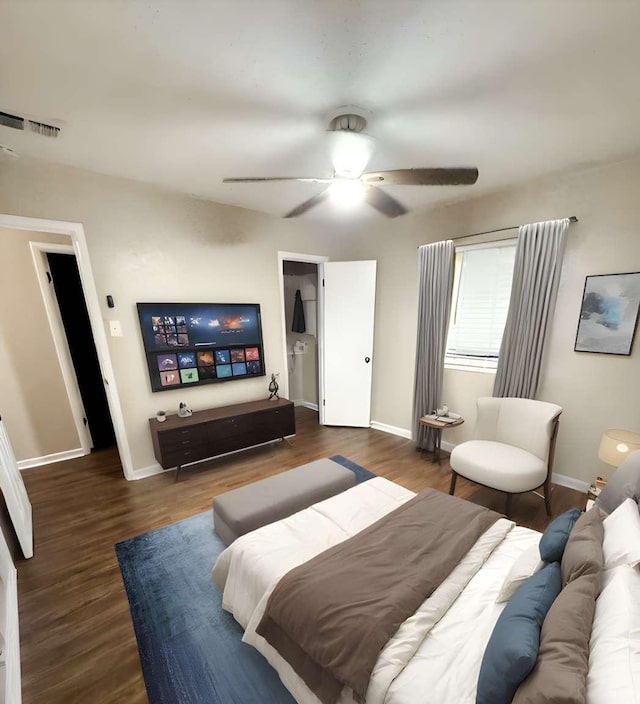 bedroom with dark hardwood / wood-style floors and ceiling fan