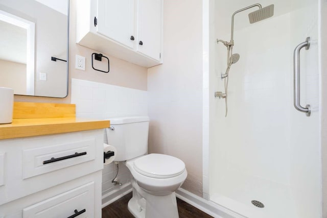 bathroom with walk in shower, vanity, and toilet