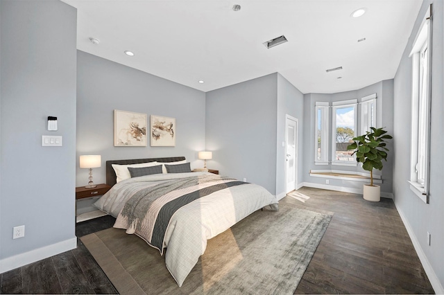 bedroom with dark hardwood / wood-style floors