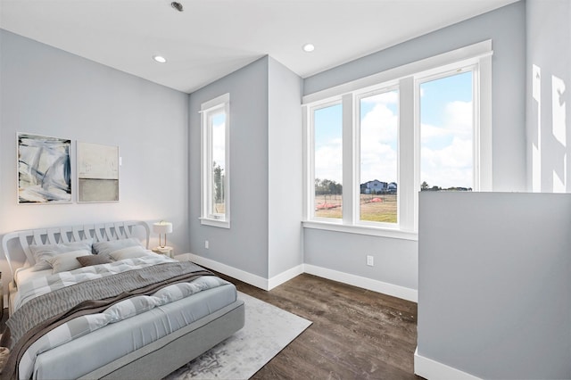 bedroom with dark hardwood / wood-style flooring