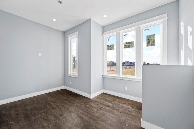 empty room with dark wood-type flooring