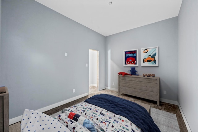 bedroom with light colored carpet and lofted ceiling