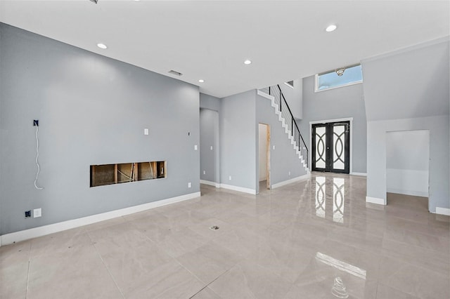 unfurnished living room featuring french doors