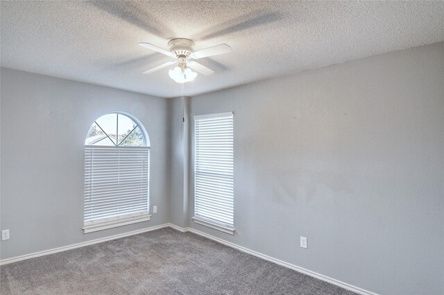 carpeted spare room with ceiling fan and a textured ceiling