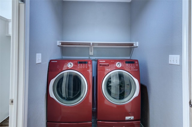 clothes washing area with washing machine and dryer