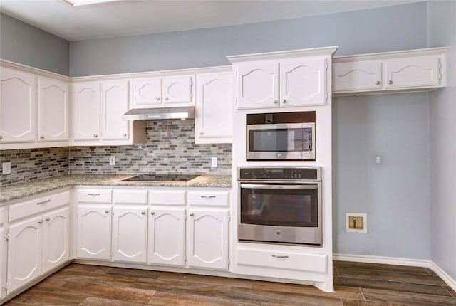 kitchen featuring light stone counters, white cabinetry, stainless steel appliances, and dark hardwood / wood-style floors