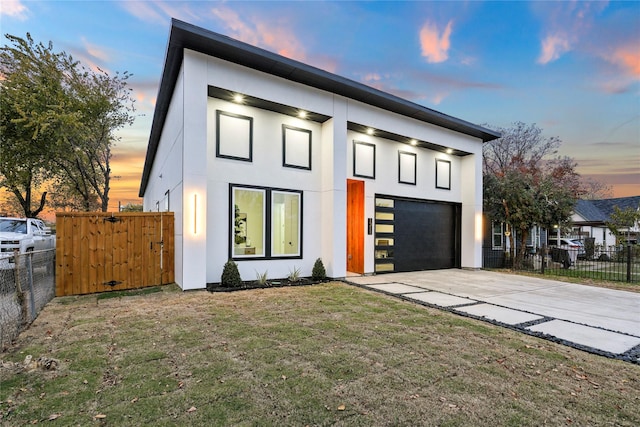 contemporary house with a lawn and a garage