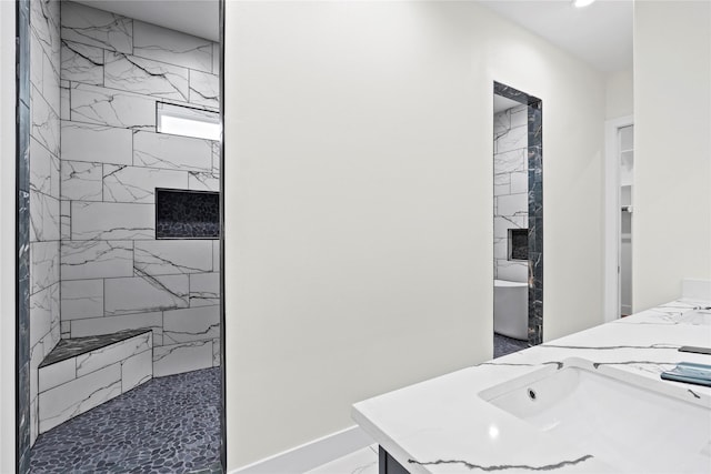 interior space with tiled shower and vanity