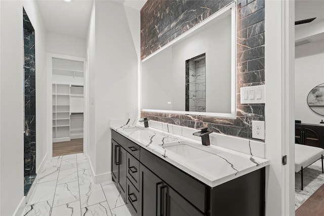 bathroom with vanity and tasteful backsplash