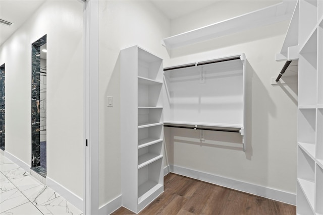 spacious closet featuring hardwood / wood-style flooring