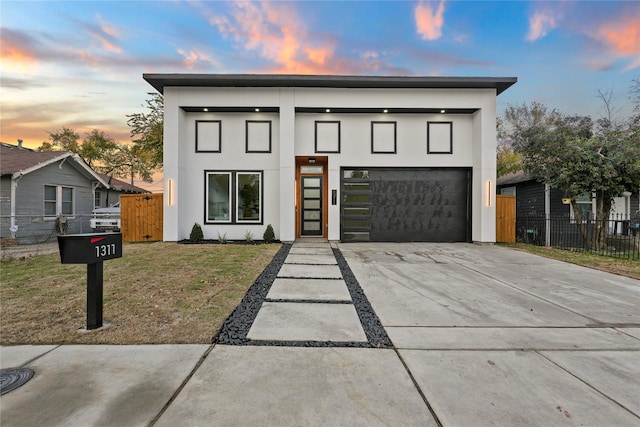 modern home with a lawn and a garage